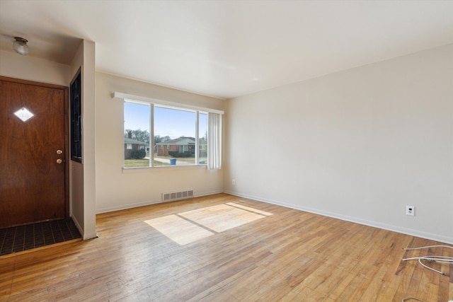 entrance foyer with baseboards, visible vents, and light wood-style floors