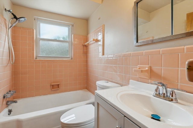 bathroom featuring toilet, a wainscoted wall, bathtub / shower combination, vanity, and tile walls