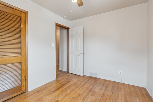 unfurnished bedroom with light wood finished floors, baseboards, visible vents, and ceiling fan