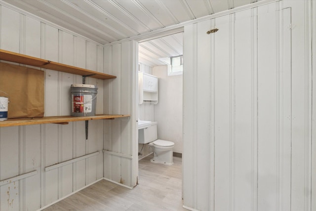 bathroom with toilet and wood finished floors