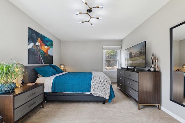 bedroom featuring a baseboard heating unit, light colored carpet, and baseboards