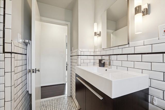 bathroom featuring tile walls and vanity