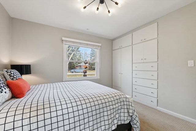 bedroom with baseboards and light colored carpet