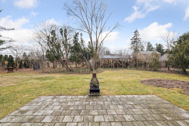 view of yard featuring a fire pit and a patio