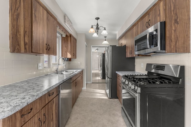 kitchen with a sink, stainless steel appliances, brown cabinets, and backsplash