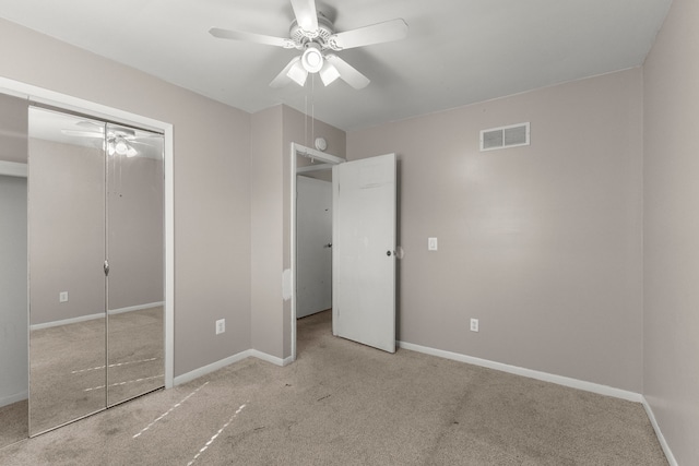 unfurnished bedroom featuring carpet, visible vents, a closet, and baseboards