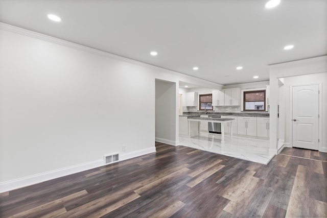 kitchen with crown molding, baseboards, dark wood finished floors, decorative backsplash, and white cabinets