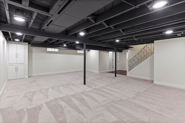 basement featuring stairs, carpet flooring, and baseboards