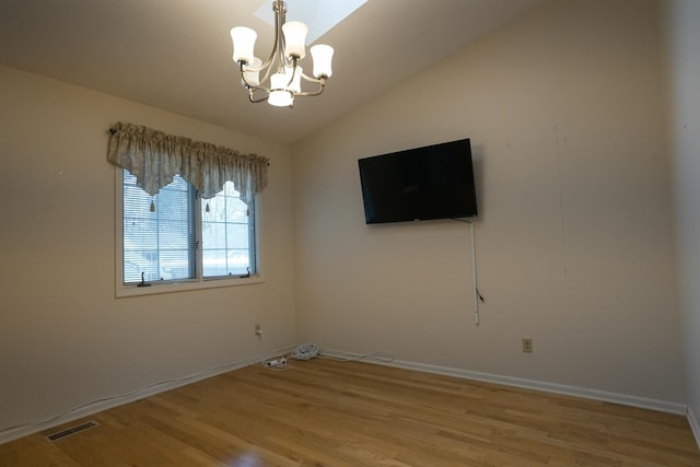 unfurnished living room featuring a chandelier, visible vents, baseboards, vaulted ceiling, and light wood-style floors