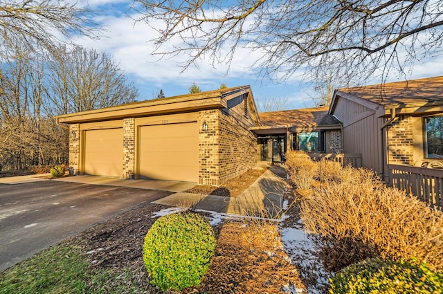 view of front facade with brick siding and driveway