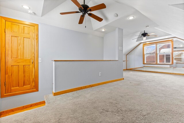 carpeted spare room featuring recessed lighting, baseboards, and vaulted ceiling