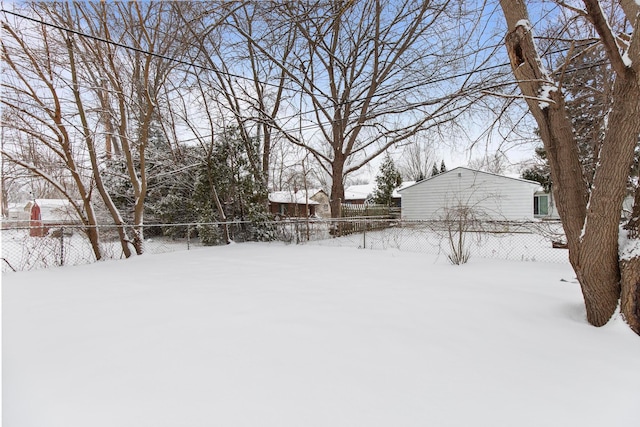 yard layered in snow with a fenced backyard