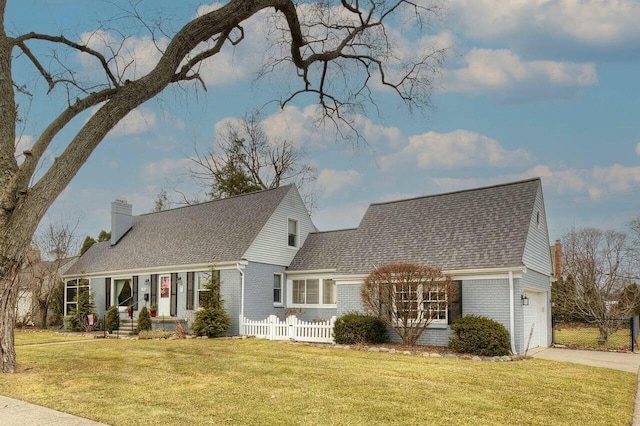 new england style home with brick siding, a chimney, fence, a garage, and driveway