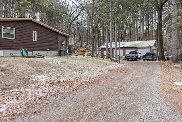 view of side of home with an outdoor structure and a detached garage