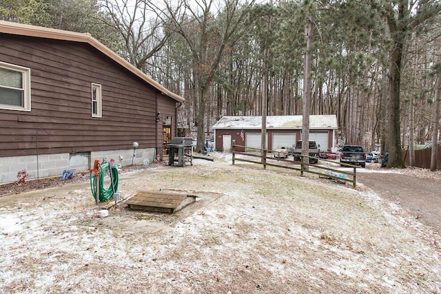 view of yard featuring a garage, an outdoor structure, and fence