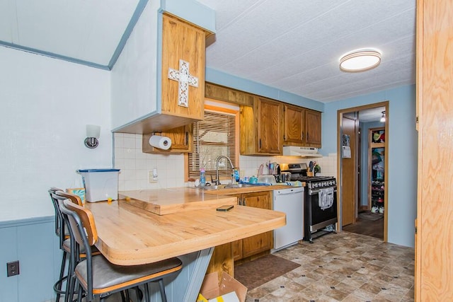 kitchen featuring white dishwasher, exhaust hood, a sink, stainless steel gas stove, and tasteful backsplash