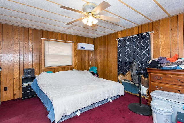 bedroom with an AC wall unit, carpet flooring, ceiling fan, and wooden walls