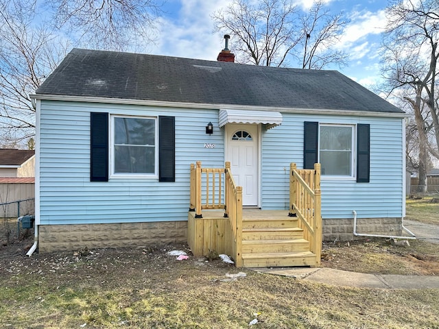 view of front of home featuring roof with shingles and a chimney