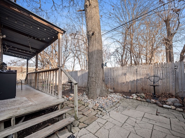 view of patio with a deck and fence