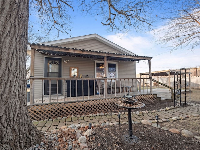 back of house featuring a porch