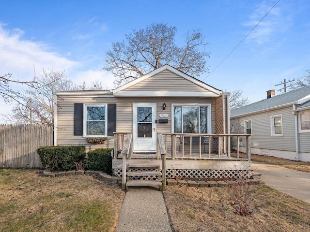 view of front of home with a wooden deck and fence