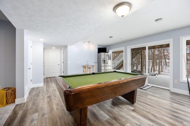 rec room with a textured ceiling, billiards, wood finished floors, and baseboards