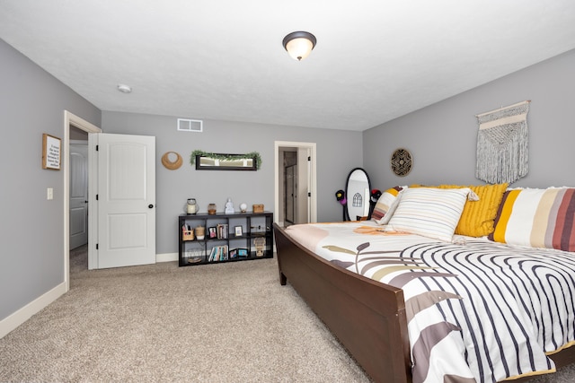 bedroom featuring carpet flooring, visible vents, and baseboards