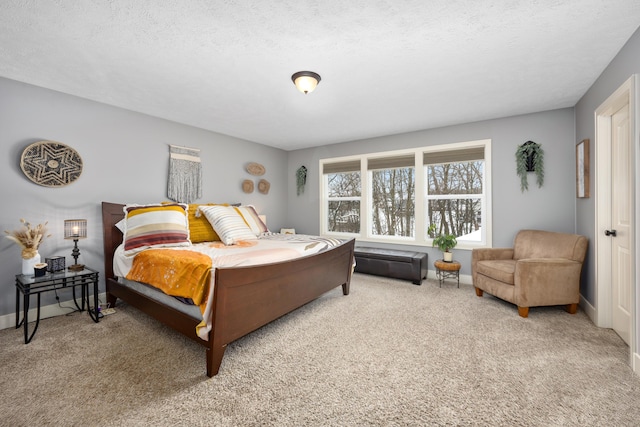 bedroom with a textured ceiling, carpet floors, and baseboards