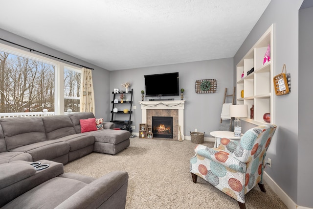 living room with carpet, a fireplace, and baseboards