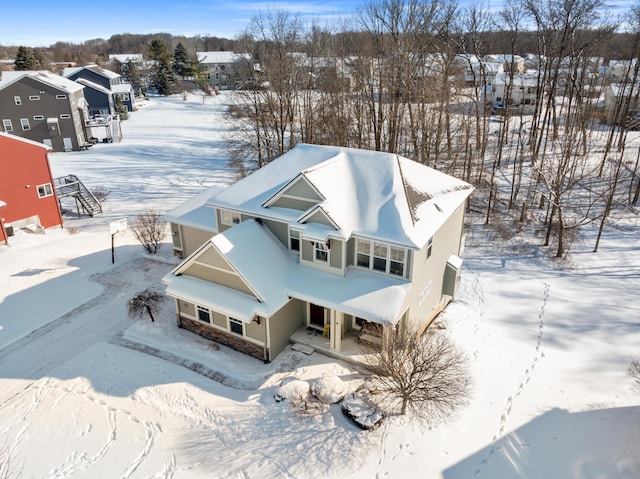 snowy aerial view featuring a residential view