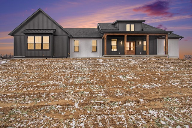 view of front of property with french doors, roof with shingles, and a porch