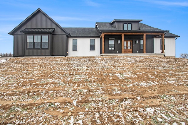 modern farmhouse featuring a shingled roof and french doors