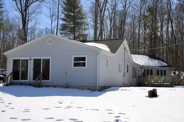 view of snow covered exterior with a deck