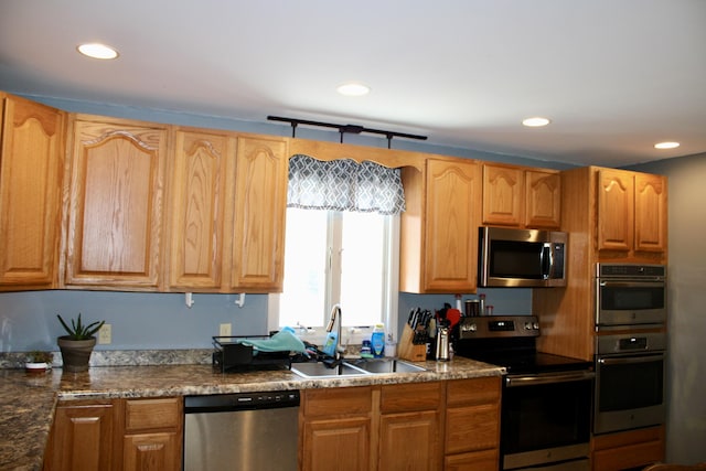 kitchen with appliances with stainless steel finishes, a sink, and recessed lighting