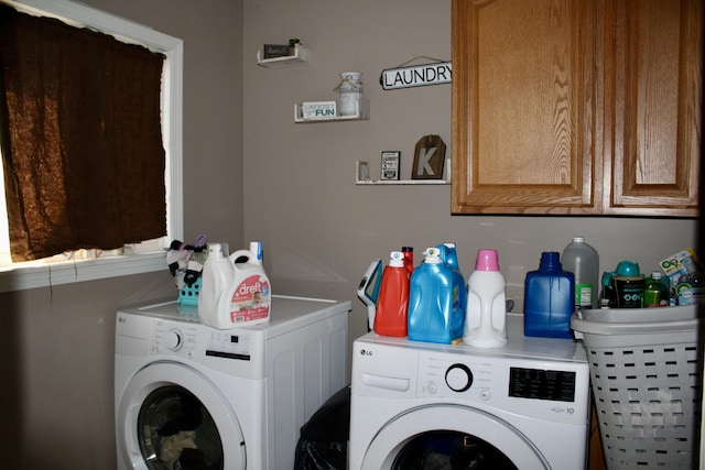 laundry room featuring washing machine and clothes dryer and cabinet space