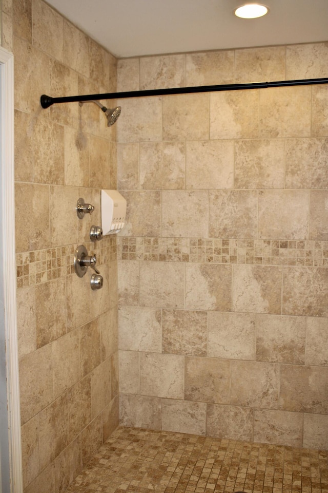 room details with a tile shower and recessed lighting