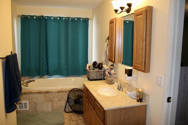 full bath featuring visible vents, a garden tub, and vanity