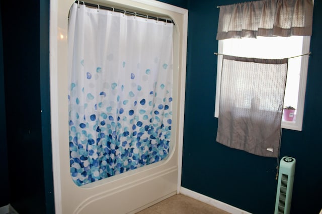 full bath with shower / bath combo, baseboards, and tile patterned floors