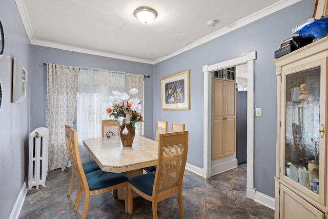 dining area featuring ornamental molding, radiator, stone finish flooring, and baseboards