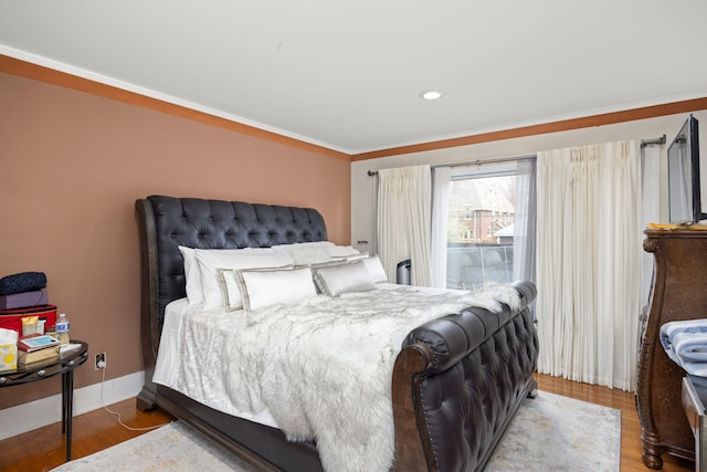 bedroom with recessed lighting, baseboards, and wood finished floors