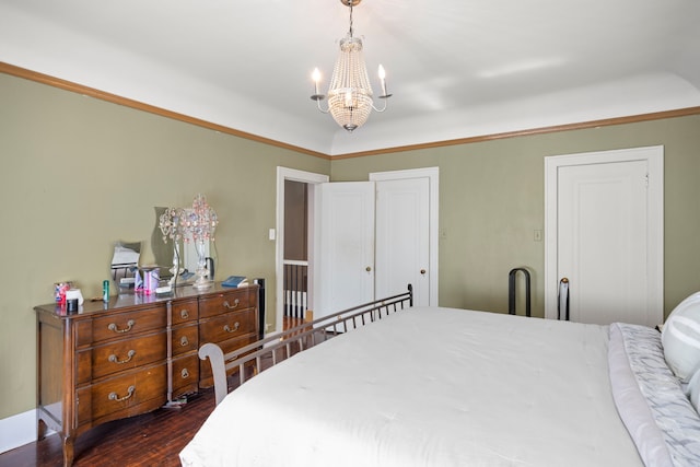 bedroom with dark wood finished floors and a notable chandelier