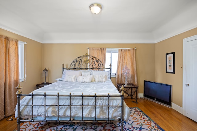 bedroom with baseboards and wood finished floors