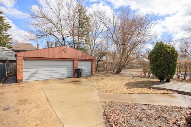 detached garage featuring fence