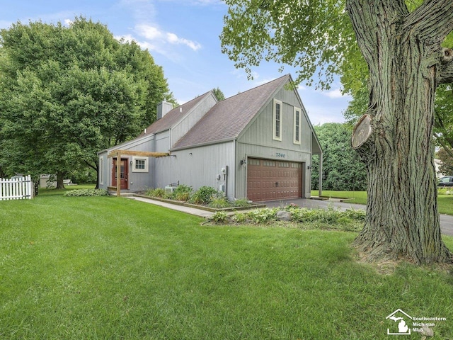 view of property exterior featuring a garage, driveway, a chimney, fence, and a yard