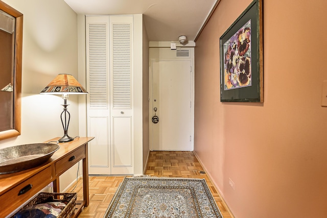 doorway to outside with visible vents and baseboards