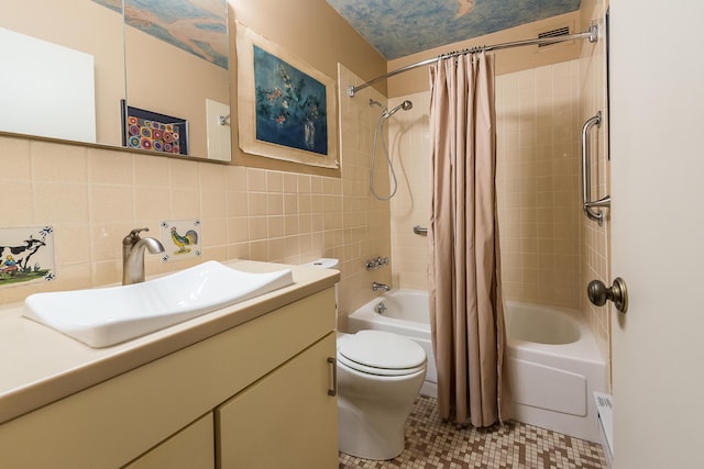 bathroom featuring toilet, tile patterned floors, shower / bath combo with shower curtain, vanity, and tile walls