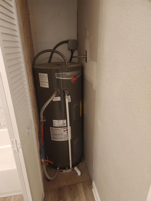 utility room with electric water heater
