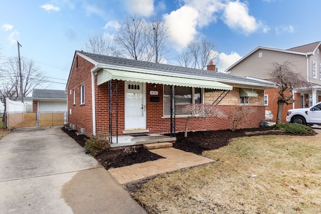 view of front of home featuring brick siding, an outdoor structure, fence, a gate, and a chimney