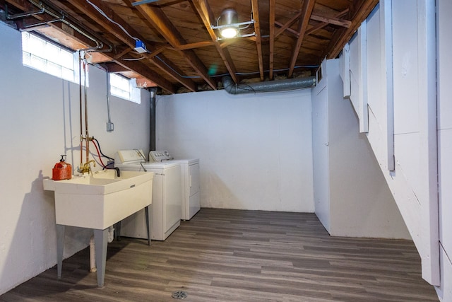 laundry room featuring a sink, laundry area, wood finished floors, and washing machine and clothes dryer