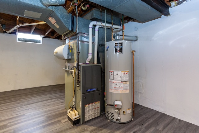 utility room with heating unit and water heater